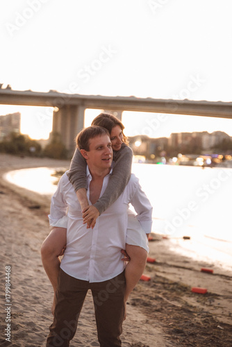 Romantic Couple Embracing at Sunset on a Beach with Soft Warm Light and Blurred Background