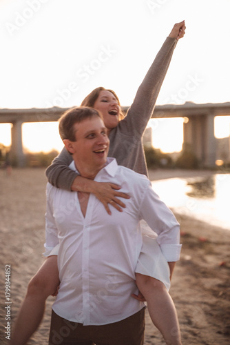 Romantic Couple Embracing at Sunset on a Beach with Soft Warm Light and Blurred Background