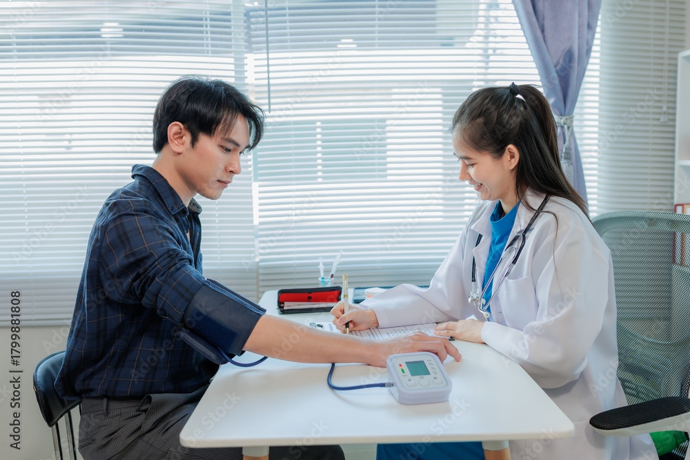 Fototapeta premium A nurse checks the patient's pressure cuff.