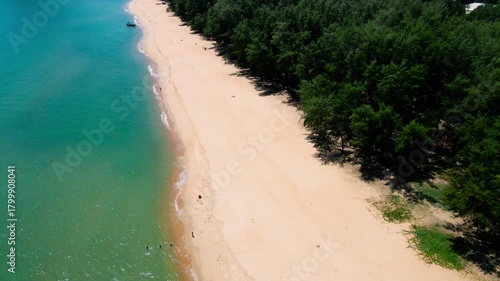 Aerial view of Pantai Bukit Keluang, Besut, Terengganu, showing turquoise waters, coastal cliffs, and clear sunny skies along the scenic shoreline.