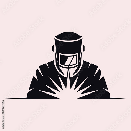 Silhouette of a welder with bright sparks emanating from work welding industry