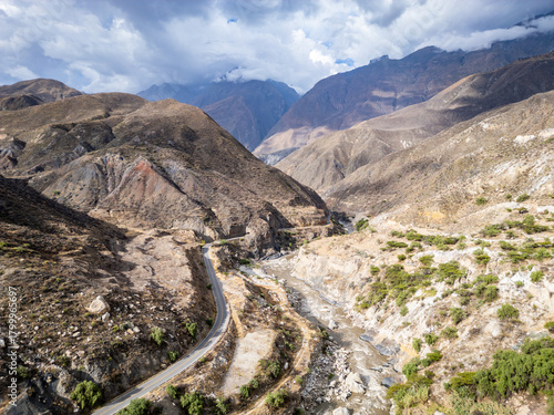 Huaraz, Peru: Aerial drone view above the road along the river Rio Santa flowing in valley of canon del pato in Huaraz region, Peru in the Andes mountain range