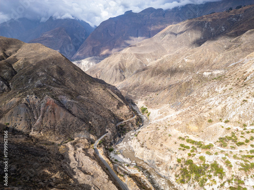 Huaraz, Peru: Aerial drone view above the road along the river Rio Santa flowing in valley of canon del pato in Huaraz region, Peru in the Andes mountain range