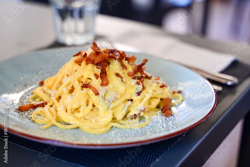 Fresh pasta    tonnarelli alla carbonara and Aperol Spritz  at  typical italian resaturant at Trastevere   neighbourhood at Rome 