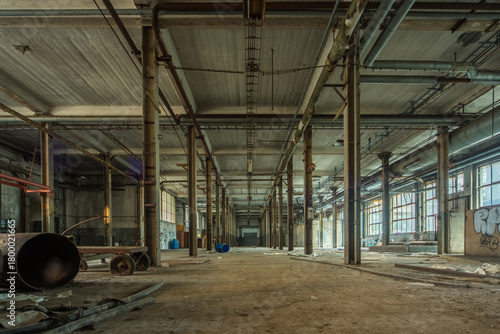 Abandoned Paper Mill Interior - Empty Post-Industrial Factory Hall with Rusted Pipes, Steel Columns and Graffiti