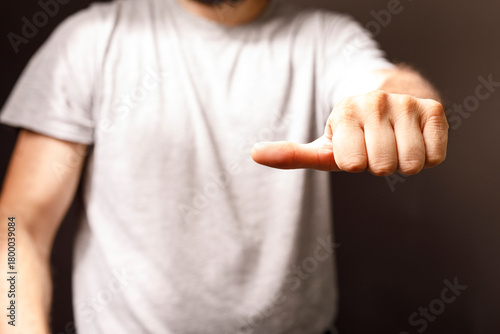 A man extends his thumb up....