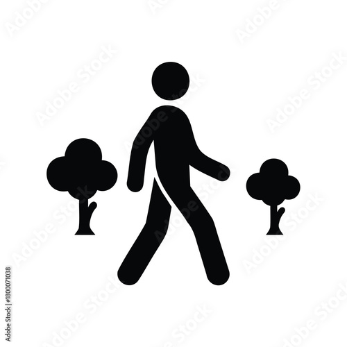 Silhouette of a person walking in a park surrounded by trees