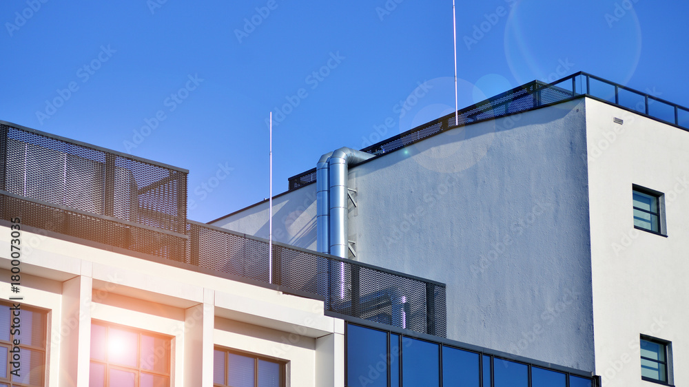 Fototapeta premium Office building in loft style. Facade of commercial office with windows. White walls of an industrial building.