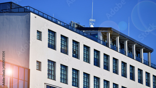 Office building in loft style. Facade of commercial office with windows. White walls of an industrial building.