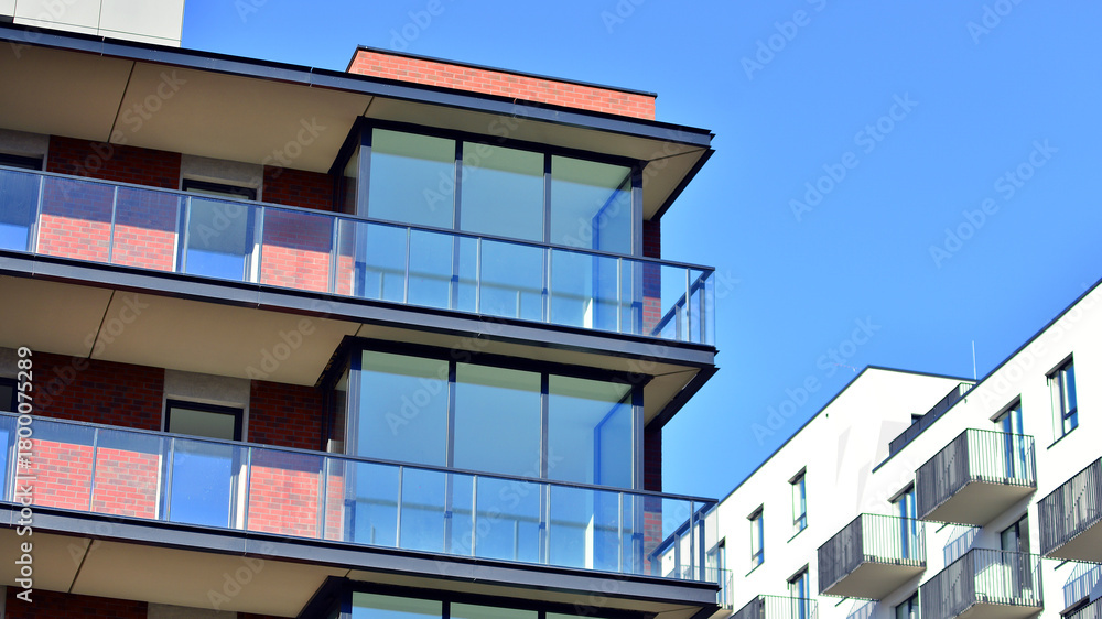 Obraz premium Modern luxury residential flat. Modern apartment building on a sunny day. Apartment building with a blue sky. Facade of a modern apartment building.