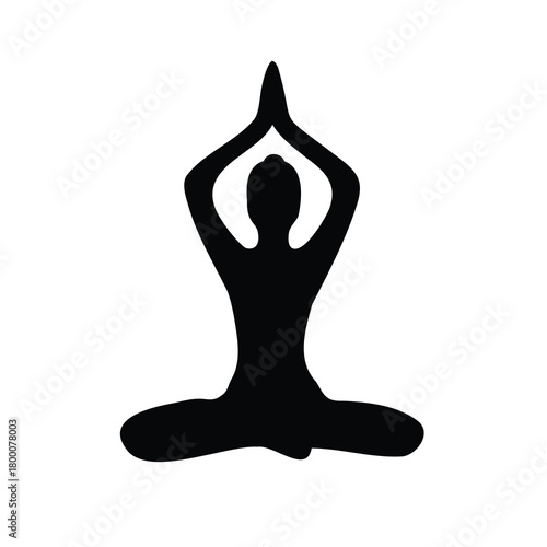Silhouette of person in yoga lotus pose with hands above head