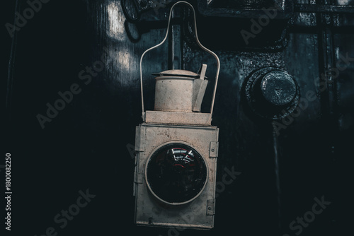 Vintage Railway Lantern Against Industrial Metal