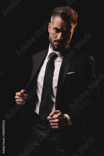 Confident man opening his suit jacket