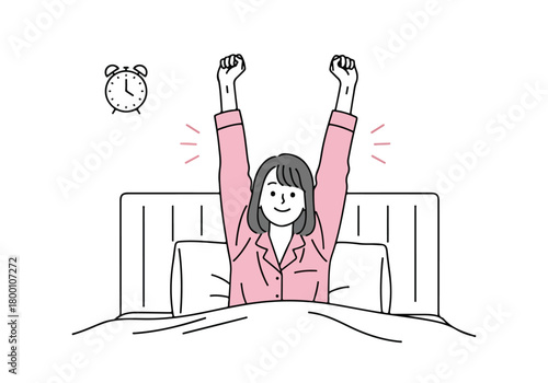 Young woman stretching in bed after waking up, feeling refreshed and ready for a productive and happy new day.