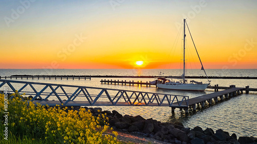 Sunset Reflections at the Marina with Sailboats and Pier