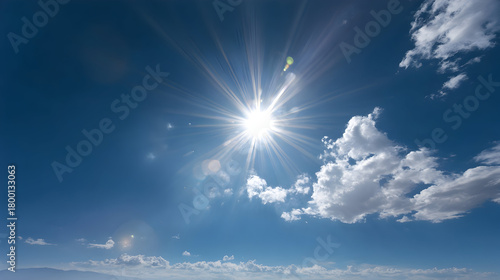 Bright midday sun shining in a clear blue sky with radiant light beams