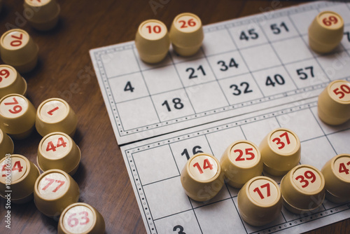 Playing lotto game. Cubes with figure on bingo card background. Nostalgia lifestyle. Table games. Retro games. Barrel with number and paper cards for bingo game. Holiday leisure. Luck concept. 