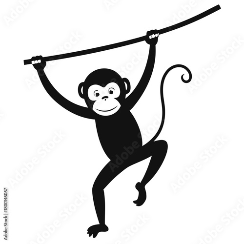 Black silhouette of a happy monkey hanging from a branch