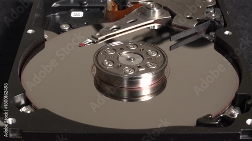 Spinning hard disk, with flashes of light and surface UN-cleaning 