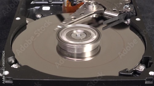 Open hard drive, close-up view, stop spinning, word DATA un-written