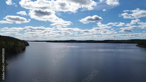 Drone flying over Lake Lelång in Sweden, capturing calm water, forested shores, and peaceful Scandinavian nature in a serene landscape.