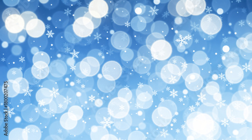 Blue Christmas background with falling snowflakes and bokeh. Abstract winter holiday and New Year celebration backdrop for a greeting card or banner