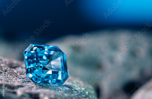 A blue gemstone sits on a rock