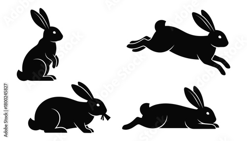Four black silhouette rabbits in different poses on white background bunny