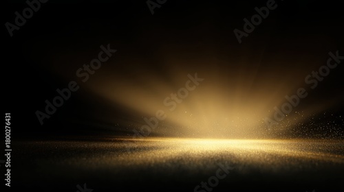 Soft radiant golden light spreading like a sunrise across smooth matte black surface, subtle particles shimmering in the air, luxury luminous