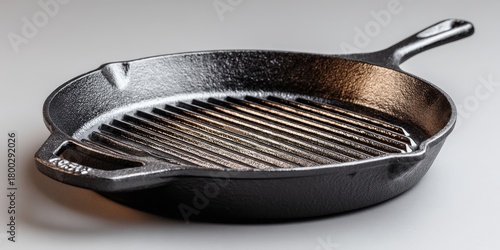 Minimalist cast iron grill pan with ridged surface and ergonomic handle for modern home cooking and kitchen design