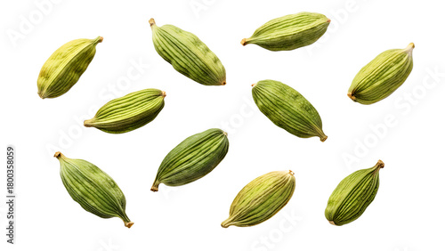 Scattered green cardamom pods aromatic spice for culinary use isolated on white background