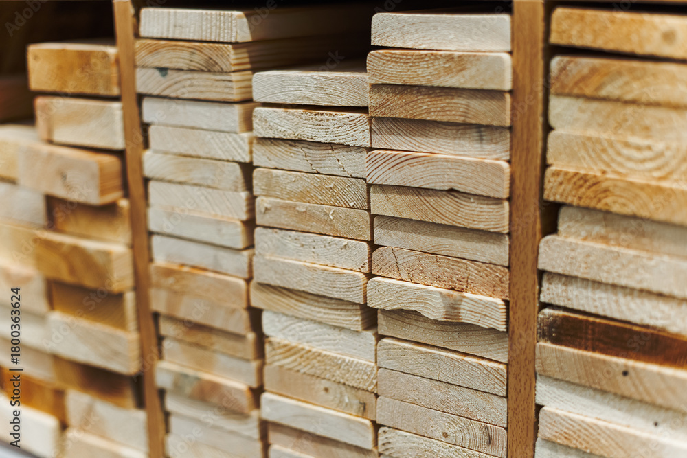 Fototapeta premium stacked wooden planks with visible grain patterns, representing building materials, craftsmanship