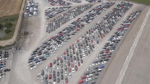 Large car lot filled with various vehicles in a rural area on a sunny day at Copart yard, York, North Yorkshire.