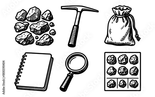 Vintage mining tools and supplies: pickaxe, rocks, notebook, magnifying glass, and sample bag