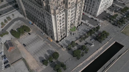 Exploring a historic building in a vibrant urban area with a spacious parking lot and nearby waterway in Liverpool.