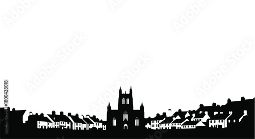 Silhouette of a historic town with a prominent church tower against a white sky.