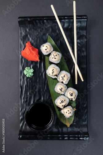 Japanese rolls, fish, black background