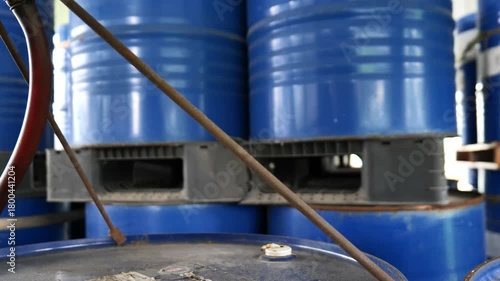 Chemical products warehouse with tiered racks storing chemical  barrels. The storage area belongs to a chemical factory and is organized inside warehouse. chemical industrial, logistic system, 