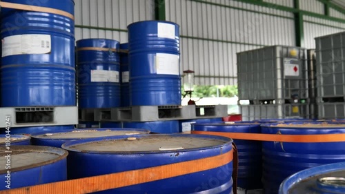 Chemical products warehouse with tiered racks storing chemical  barrels. The storage area belongs to a chemical factory and is organized inside warehouse. chemical industrial, logistic system, 
