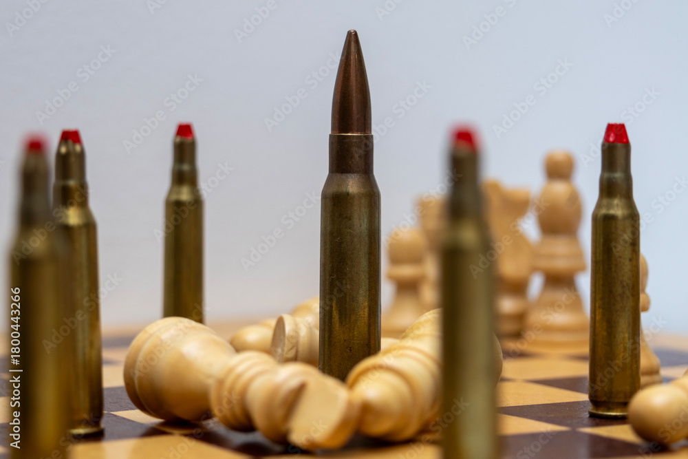 Low-angle close study of rounds and fallen pawns across a chessboard; metallic forms and wooden pieces create textural contrast while the tableau evokes tactical consequence and small-scale conflict.
