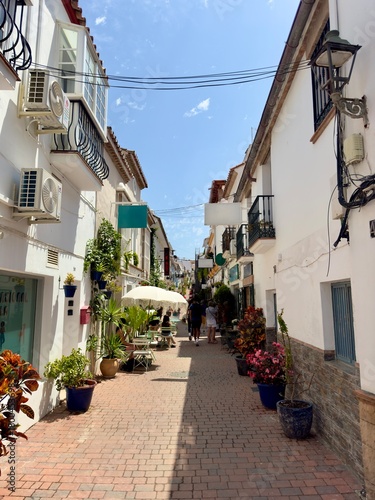 narrow beautiful street in the old town of Estepona with lots of flowers, Costa del Sol, Málaga, Andalusia, Spain
