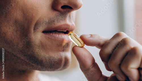 Man Taking Softgel Supplement Close Up