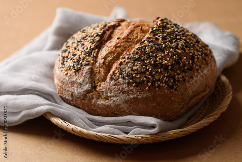 Healthy vegan dark rye sourdough bread topped with sesame and flaxseed