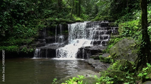 Natural waterfall in the middle of the green forest