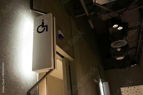 Illuminated Restroom Signage. A modern, vertically oriented sign for an accessible restroom.