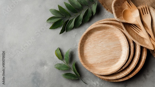 Wallpaper Mural Light-colored, natural plates, cutlery, and leaves arranged on a gray surface Torontodigital.ca