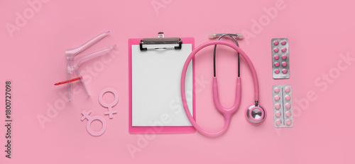 Foto Clipboard with stethoscope, symbols of woman, pills and gynecological speculum o