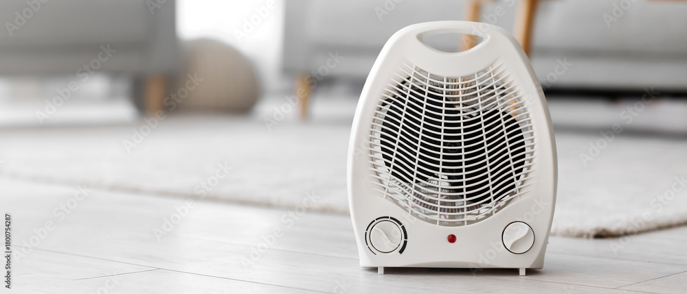 Fototapeta premium Electric fan heater on floor in living room
