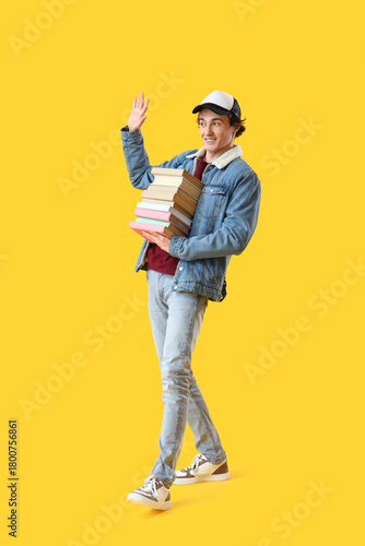 Young man with stack of boo...