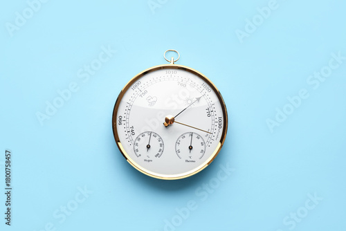 Aneroid barometer on blue background